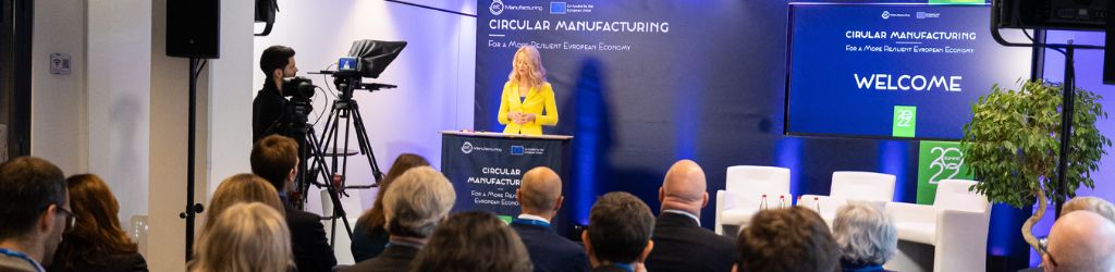 Image showing the moderator Karin Helmstaedt on stage, welcoming the audience for the EIT Manufacturing Summit Days 2022.